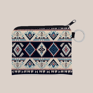 Macro shot of Aztec pattern coin purse showing woven canvas texture and silver key ring