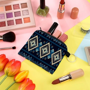 Aztec print coin purse with navy geometric pattern and metal ring on colorful background