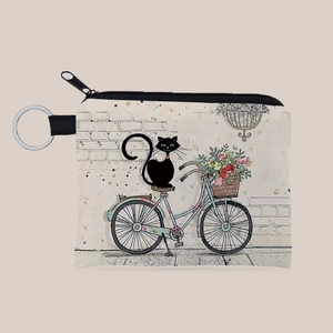 Detail of canvas coin purse with cute cat and bicycle print featuring a metal keychain