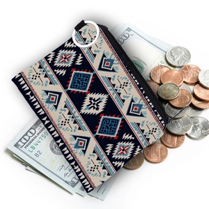 Aztec print coin purse with metal keyring shown holding bills and coins on white background