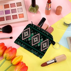 Aztec print coin purse detail with metal ring among cosmetics and makeup tools