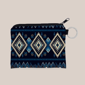 Close-up of bohemian Aztec print coin purse with navy geometric patterns and key ring