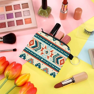 Aztec print coin purse with silver ring keychain displayed with makeup accessories