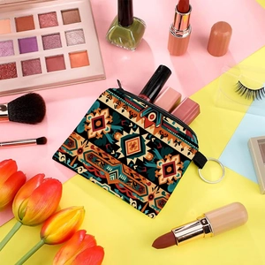 Aztec print coin purse with keychain ring styled with cosmetics and tulips