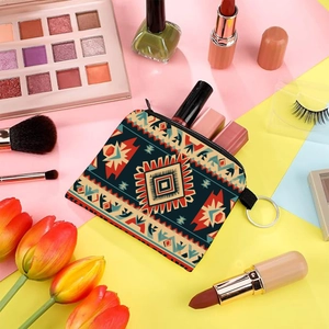Aztec print coin purse with tribal geometric patterns and a round zipper puller close-up