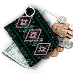 Detail of aztec print coin purse with silver key ring showing coins and zipper closure