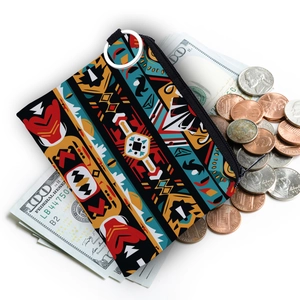 Detail view of Aztec print coin purse with silver metal ring and scattered currency