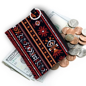 Aztec print coin purse with tribal patterns and silver keychain shown with cash
