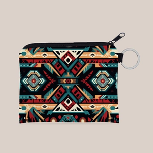 Close-up of small canvas coin purse featuring colorful Aztec geometric patterns and a keychain