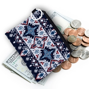 Aztec print small coin purse featuring navy blue geometric patterns with dollar bill props
