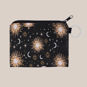 Detailed macro of fabric coin purse featuring celestial moon and star patterns with key ring