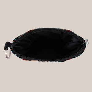 Close-up of ethnic Aztec pattern coin purse with black lining and metal keychain ring