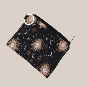 Close-up of black celestial canvas coin purse with gold sun and moon patterns and key ring