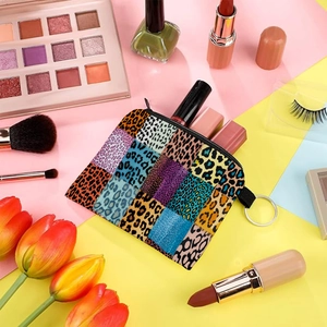 Detail shot of leopard patchwork coin purse showing zipper and lipstick storage
