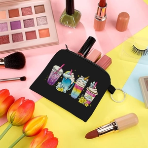 Close-up of portable coin purse with cartoon drink prints and makeup accessories