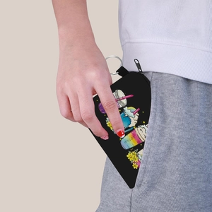 Black canvas coin purse with cartoon rainbow print being tucked into a pocket