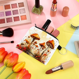 Colorful mushroom print coin purse with zipper and keychain displayed with makeup tools