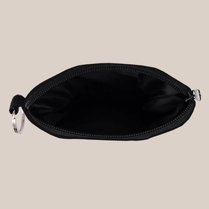 Internal view of black nylon coin pouch showing durable lining and metal keychain ring