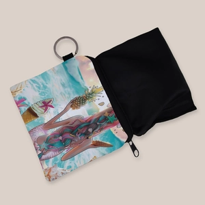 Detail view of mermaid print coin purse with a sturdy metal keychain and zipper closure