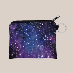 Detail of the sun and moon celestial print on a portable coin purse with key ring