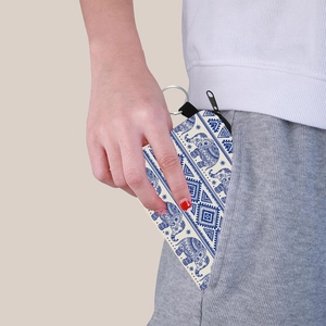 Petit porte-monnaie à imprimé éléphant avec porte-clés glissé dans une poche