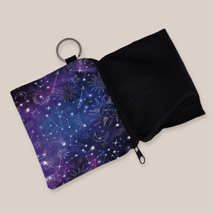 Square celestial coin purse with star, moon, and sun print featuring a metal keychain hook