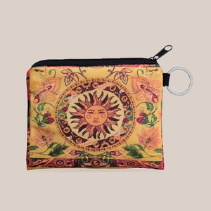 Detailed view of yellow canvas sunflower coin purse with bohemian sun patterns and metal keychain