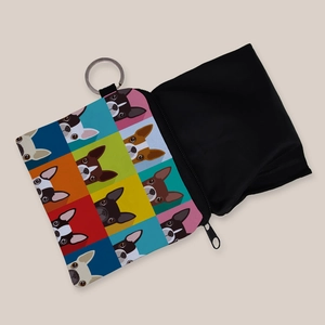 Detailed macro view of an open square coin purse featuring dog pop art and a black interior