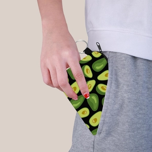 Detail showing avocado print coin purse being tucked into a pocket for portability