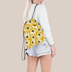 Vibrant yellow drawstring backpack with daisy print pattern worn by a model