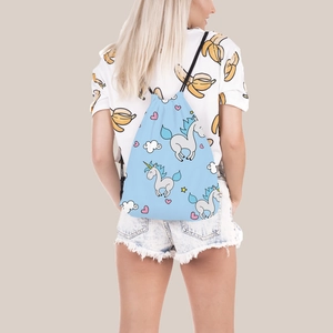 Light blue drawstring backpack with cartoon unicorn prints shown on a female model