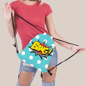 Detail view of light blue drawstring bag with white polka dots and BANG! graphic print