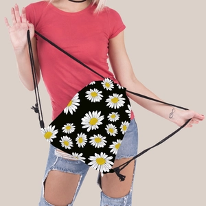 Detail of sunflower print drawstring bag worn by model over a red shirt and jeans