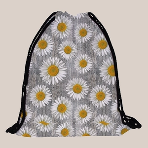 Detailed view of sunflower print drawstring bag with wood texture background and white daisies