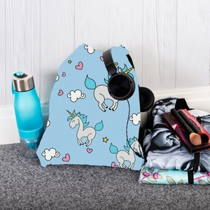 Detail of light blue drawstring backpack featuring cute unicorn and star cartoon prints