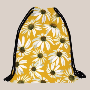 Detail of yellow drawstring backpack with white daisy pattern and black rope cord