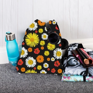 Detail of floral drawstring backpack with sunflower print and travel essentials set