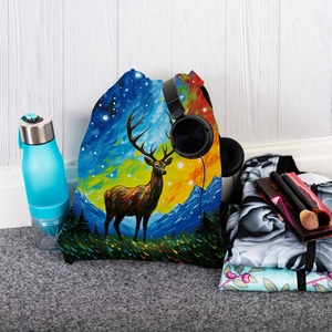 Flat lay of colorful deer print drawstring backpack with travel essentials on grey carpet