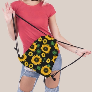 Close-up of portable drawstring backpack featuring bright sunflower print and cotton cords