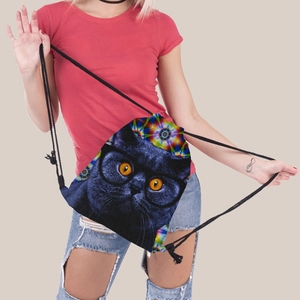 Detail of drawstring backpack featuring a black cat print and vibrant floral patterns