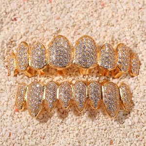 Macro detail of gold plated 8-tooth grillz set with micro-paved cubic zirconia
