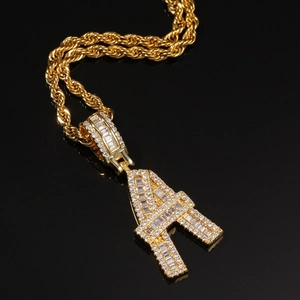 Macro shot of gold hip-hop letter A pendant with sparkling baguette zircon stones