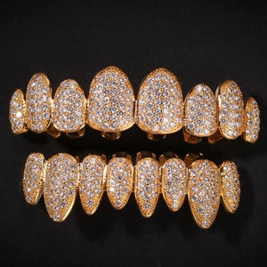 Macro detail of iced out gold hip hop grillz with shimmering pavé set cubic zirconia