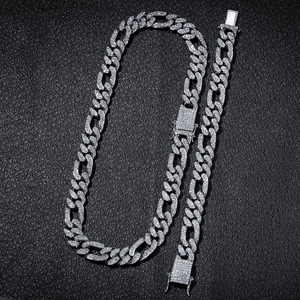 Detail of silver iced-out Cuban Figaro chain set with sparkling rhinestones and buckle