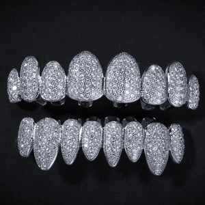 Macro detail of silver hip hop grillz with full micro paved white zircon stones