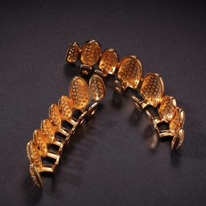 Detail of hiphop gold grillz set with micro-pave cubic zirconia on irregular 8-teeth frame