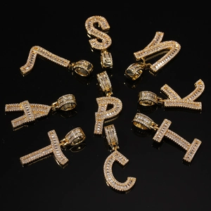 Elegant gold initial pendants featuring baguette and round cubic zirconia stones