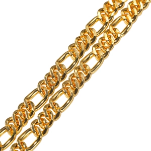 Macro view of gold Figaro chain link with polished finish and diamond-encrusted details
