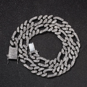 Close-up of iced out Cuban link chain necklace with sparkling zircon pavé on black background