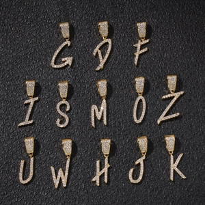 Macro view of gold-plated hip hop letter pendants G to K with sparkling cubic zirconia
